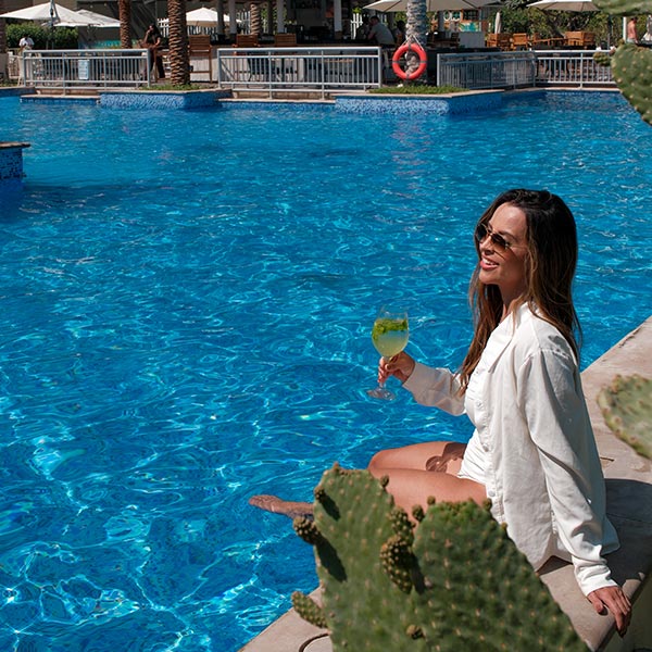 Ladies enjoying a sunny poolside afternoon at Riva Beach Club