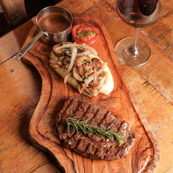 Steak and drink offer served by the waterfront at Riva Beach Club
