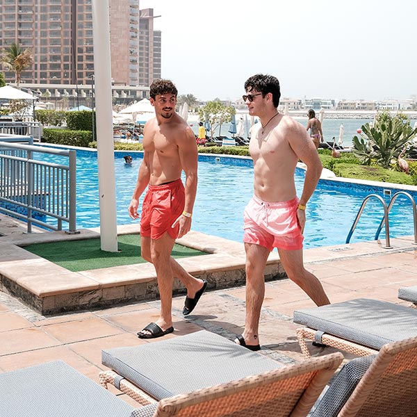 Guest enjoying a drink by the pool at Riva