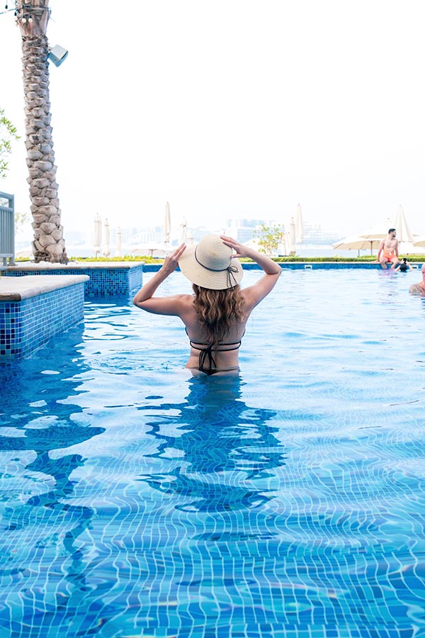 Ladies enjoying a sunny poolside afternoon at Riva Beach Club