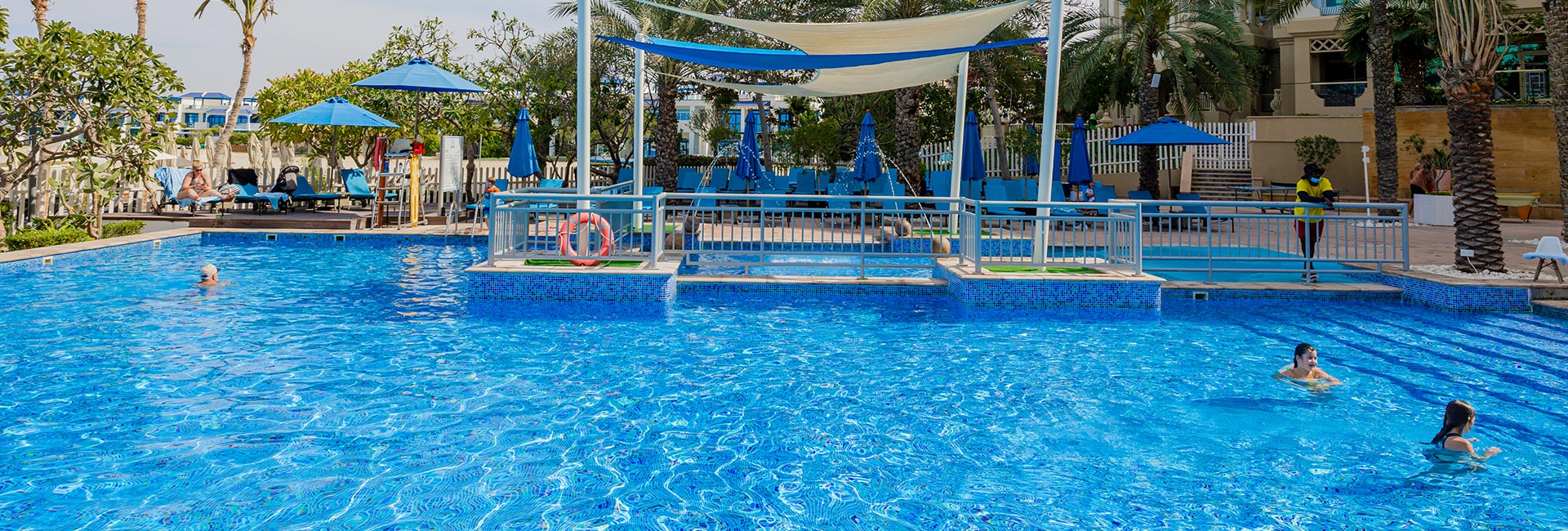 Guests enjoying the pool at Riva Beach Club