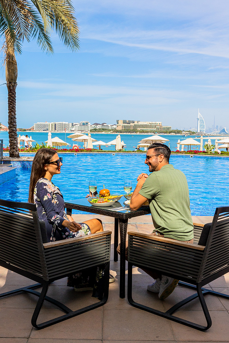 Riva Beach Club pool and beach umbrellas